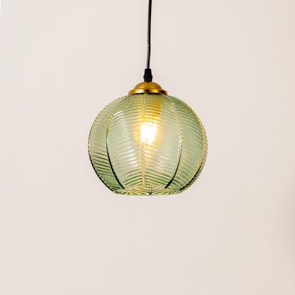 Contemporary pendant light in gold metal finish with green glass shade for dining room or kitchen decor lighting white background.