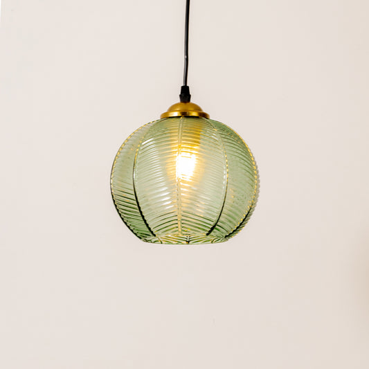 Contemporary pendant light in gold metal finish with green glass shade for dining room or kitchen decor lighting white background.