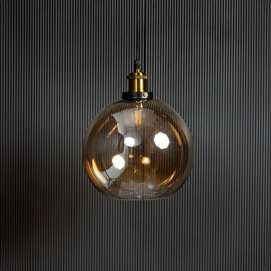 Amber glass pendant light turned off displayed on black background is a stylish glass lighting fixture.