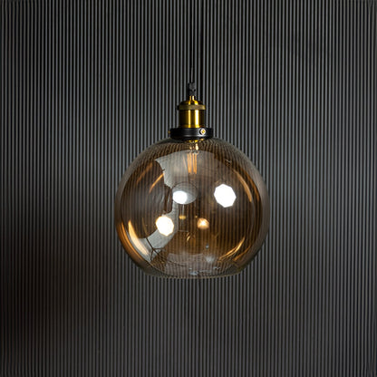 Amber glass pendant light turned off displayed on black background is a stylish glass lighting fixture.
