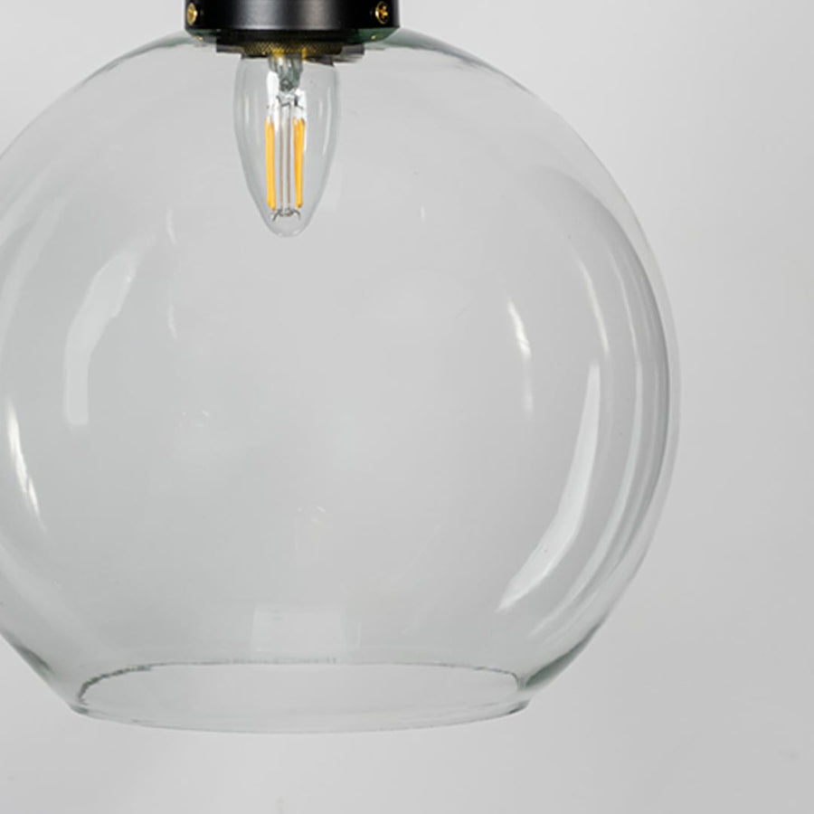 Clear glass pendant light with brass metal fixture showcasing smooth transparent finish and contemporary lighting style.
