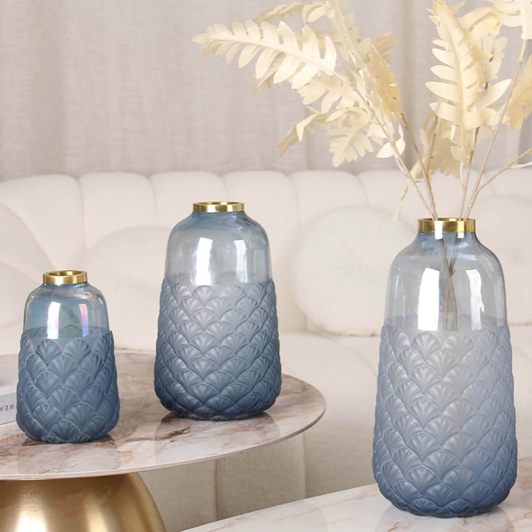 Grouped tall blue glass vase with medium and small sizes styled on marble table for modern living room home decoration glass vase.