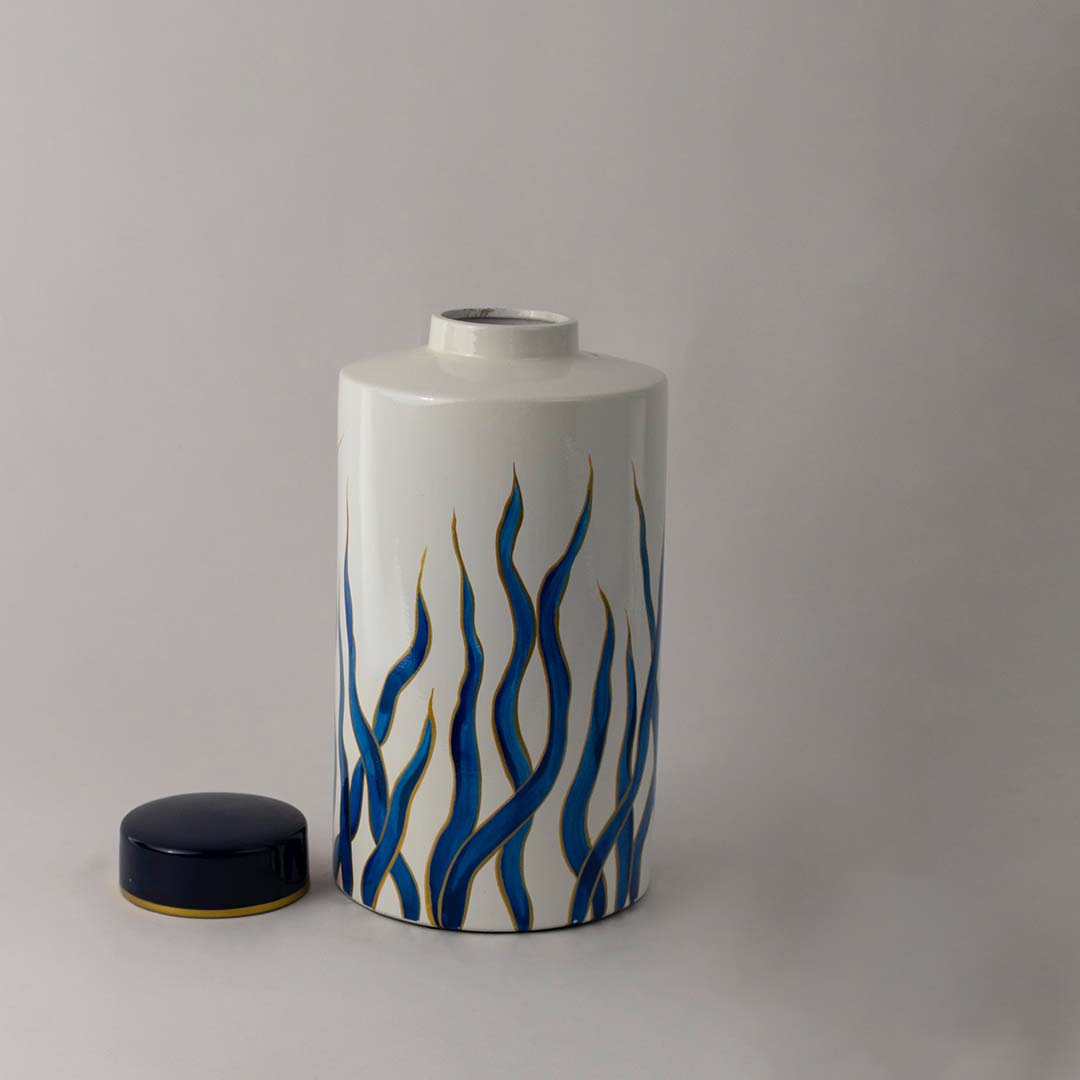 Modern white ceramic jar with elegant blue wave design and golden rim crafted for stylish home and tabletop decor.