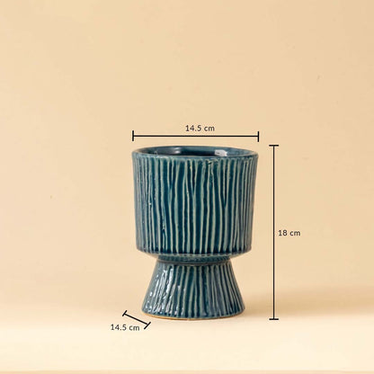 Blue textured vase with vertical line detailing shown clearly with dimensions 14 point 5 cm width 14 point 5 cm base width and 18 cm height.