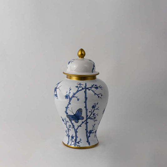 Handcrafted ceramic jar with blue floral butterfly pattern and golden lid perfect for classic home decor styling.
