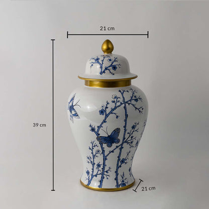 Blue and white ceramic jar with butterfly design and golden lid shown with 39 cm height and 21 cm width dimensions