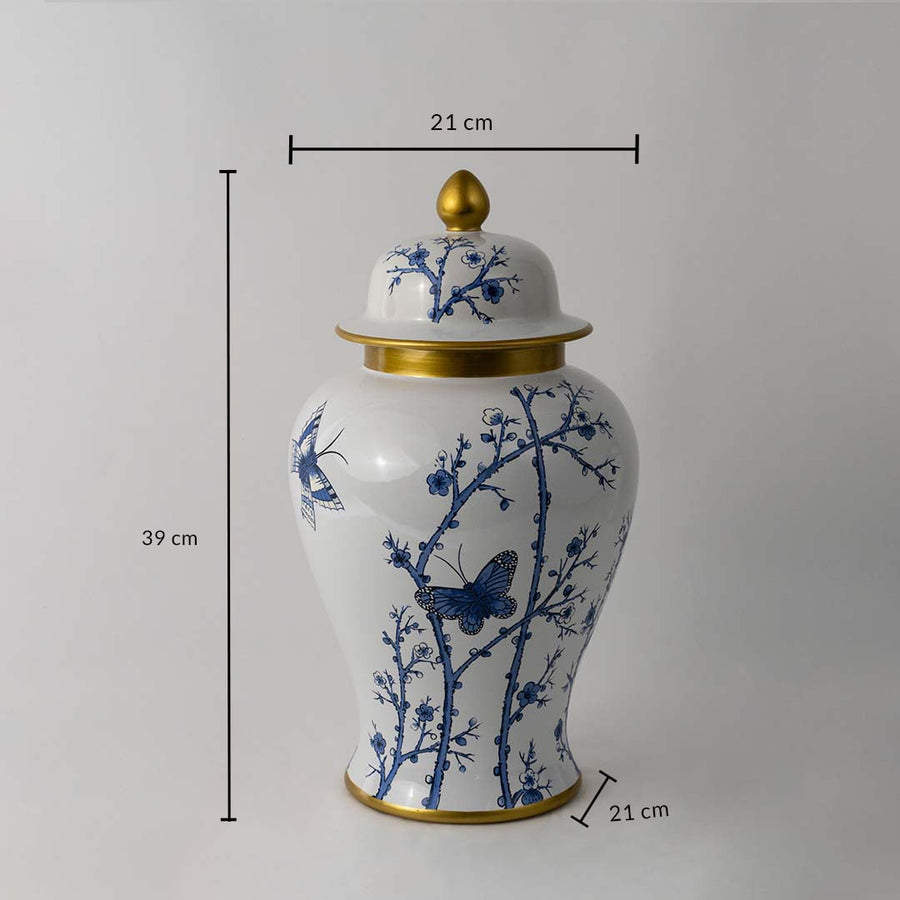 Blue and white ceramic jar with butterfly design and golden lid shown with 39 cm height and 21 cm width dimensions