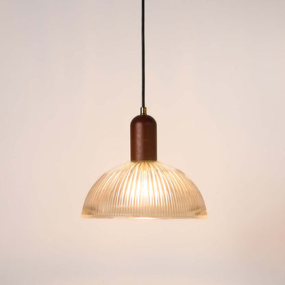 Ribbed clear glass and walnut wood pendant light with warm glow for elegant modern home decor spaces.