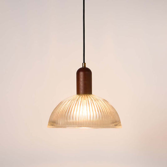 Ribbed clear glass and walnut wood pendant light with warm glow for elegant modern home decor spaces.