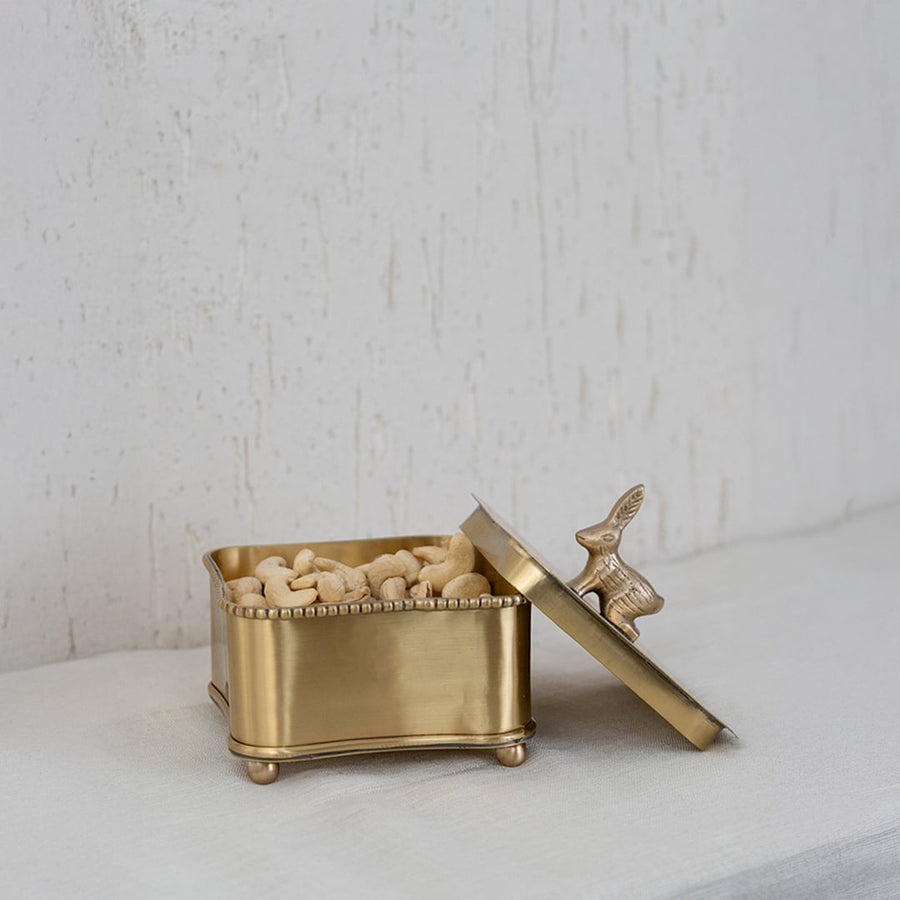 Gold bird-lid storage box securely packed in a premium black box with cushion insert for elegant gifting and safety.