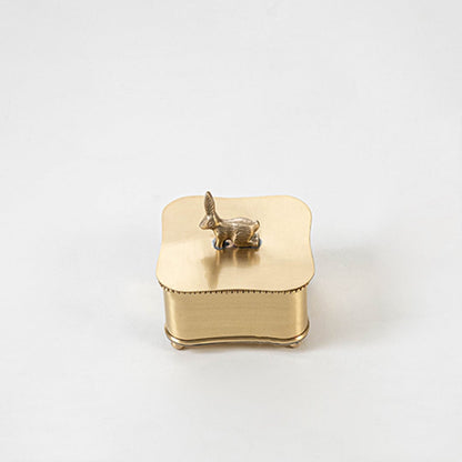 Gold decorative box with bird handle lid placed on a white background showcasing polished metallic finish and shape.