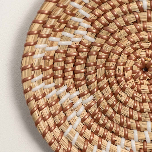 Detailed closeup view of the tight weaving technique and natural color variations on the seagrass wall basket surface quality.