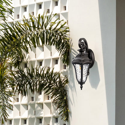 Antique lantern wall light mounted on an exterior wall creates a welcoming atmosphere for outdoor spaces.