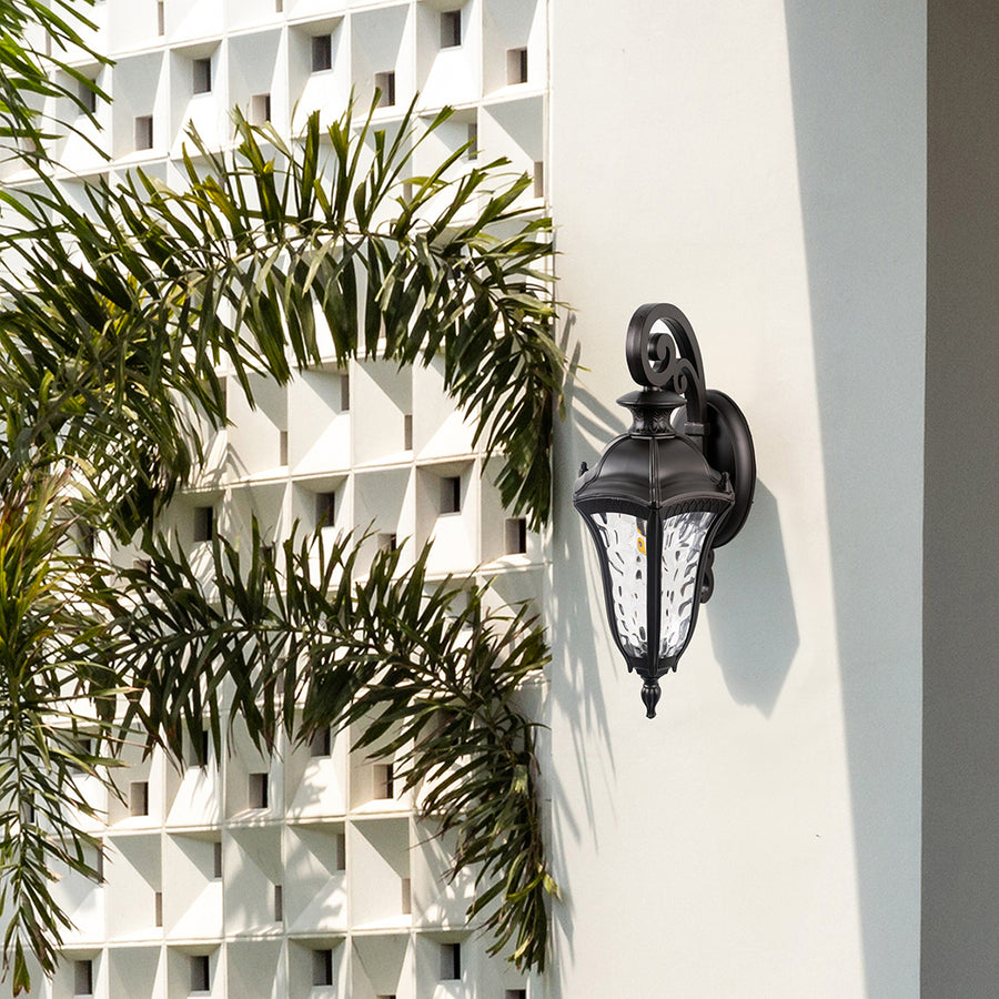 Antique lantern wall light mounted on an exterior wall creates a welcoming atmosphere for outdoor spaces.