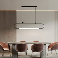 Black metal linear LED pendant light above dining table creating sophisticated ambient lighting for modern interiors.