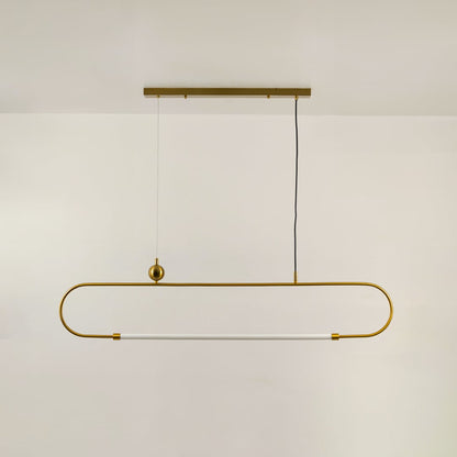 Gold metal linear pendant light on a white background with the light off highlighting its sculptural modern silhouette.
