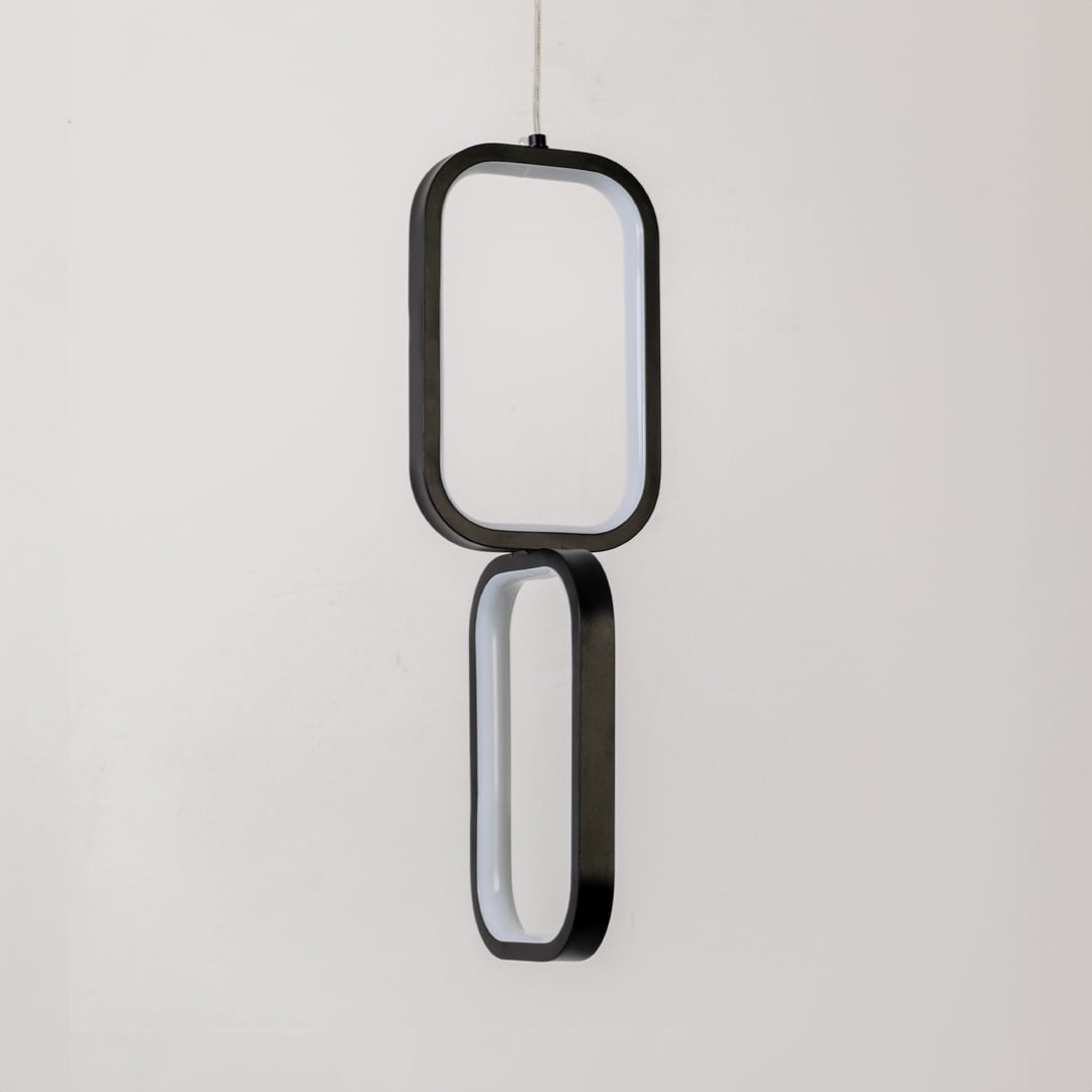 Black and white metal dual frame hanging light shown switched off on white background for minimal clean wall decor.