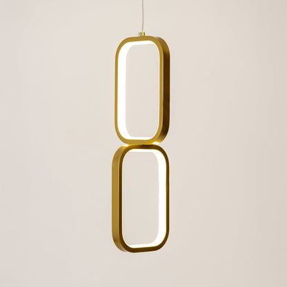 Gold and white metal dual frame hanging light glowing softly on white background for elegant contemporary wall decor.