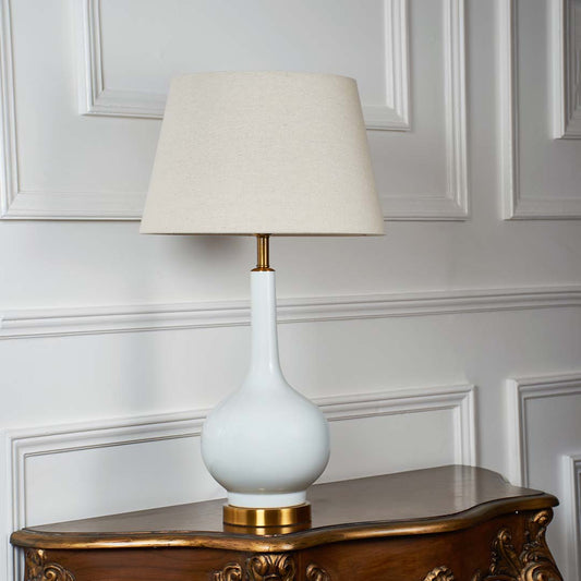 White fabric shade table lamp with glossy white ceramic base and gold accent for bedroom living room and side table decor.