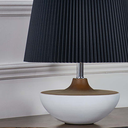 Closeup of black pleated table lamp shade showing detailed texture and golden neck accent for luxury appeal.