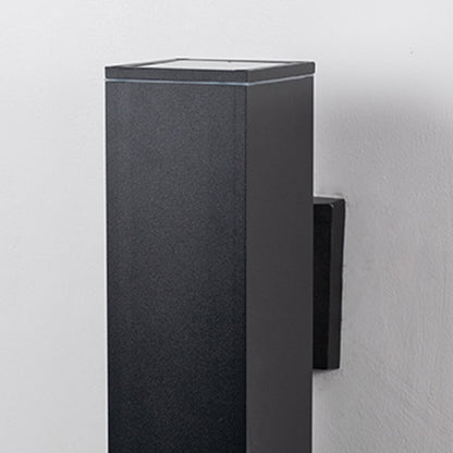 Closeup of rectangular black wall light featuring sleek lines and modern metallic texture with smooth edges.
