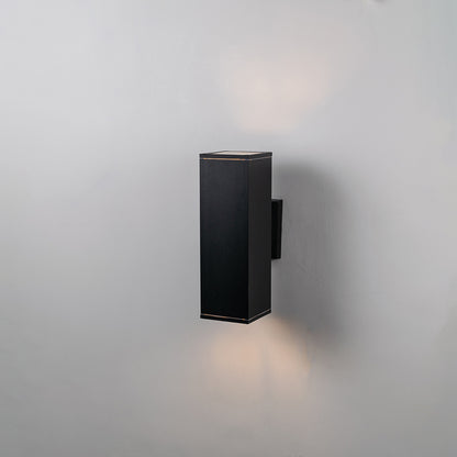 Black metal outdoor wall light on white background with soft downward glow for minimalist exterior decor.