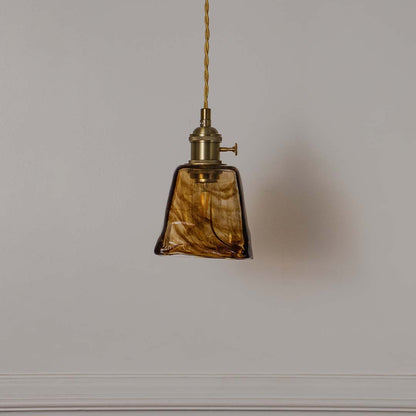 Amber marbled glass pendant light with antique brass fittings crafted for elegant contemporary interiors.