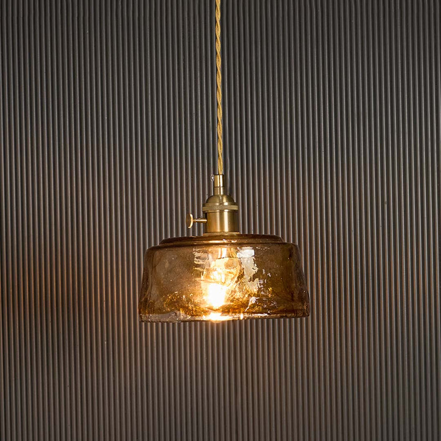 Amber glass pendant light glowing on black background highlighting warm illumination through textured vintage industrial shade.
 RetryClaude can make mistakes. Please double-check responses. Sonnet 4.5