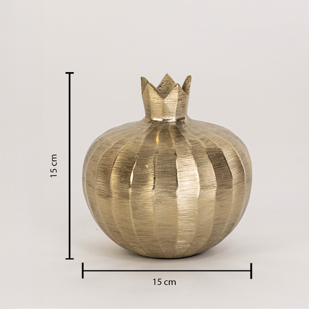 Gold decorative pomegranate sculpture measuring 15 cm tall and 15 cm wide shown with textured finish on white wall
