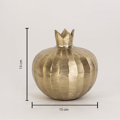 Gold decorative pomegranate sculpture measuring 15 cm tall and 15 cm wide shown with textured finish on white wall