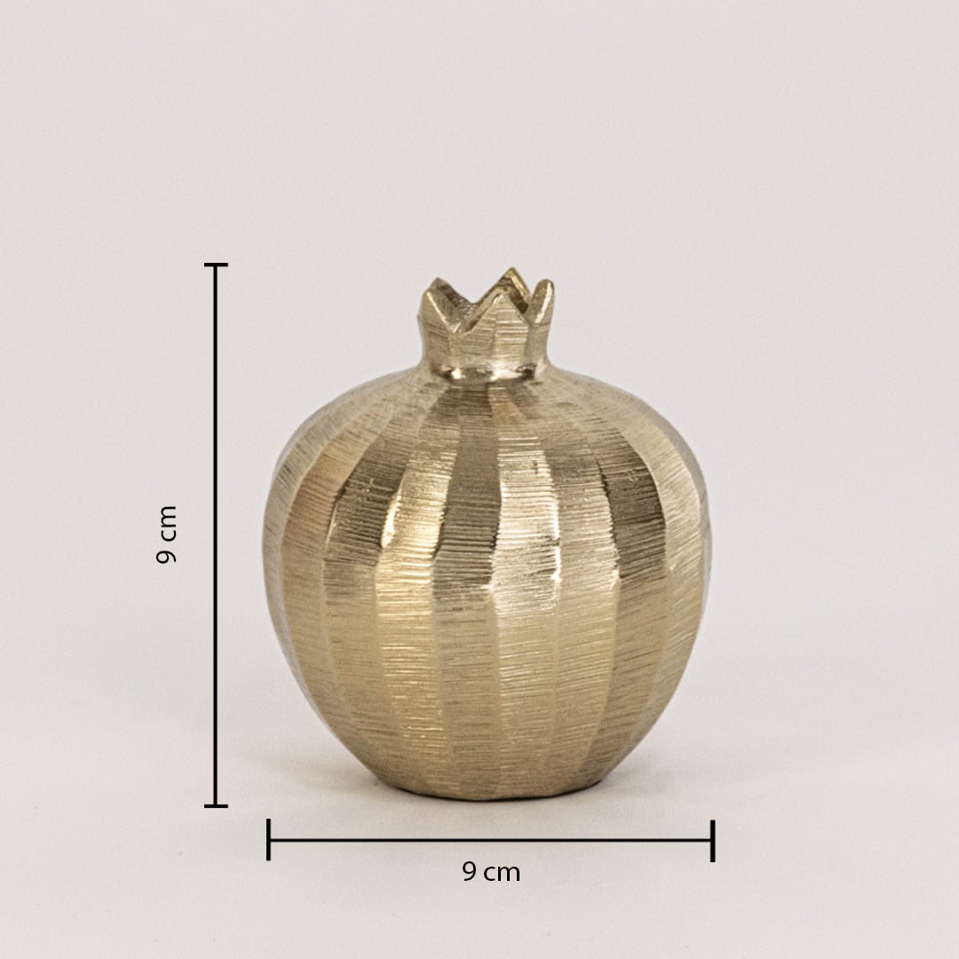 Gold pomegranate decor piece measuring 9 cm tall and 9 cm wide with textured finish shown on plain white backdrop.