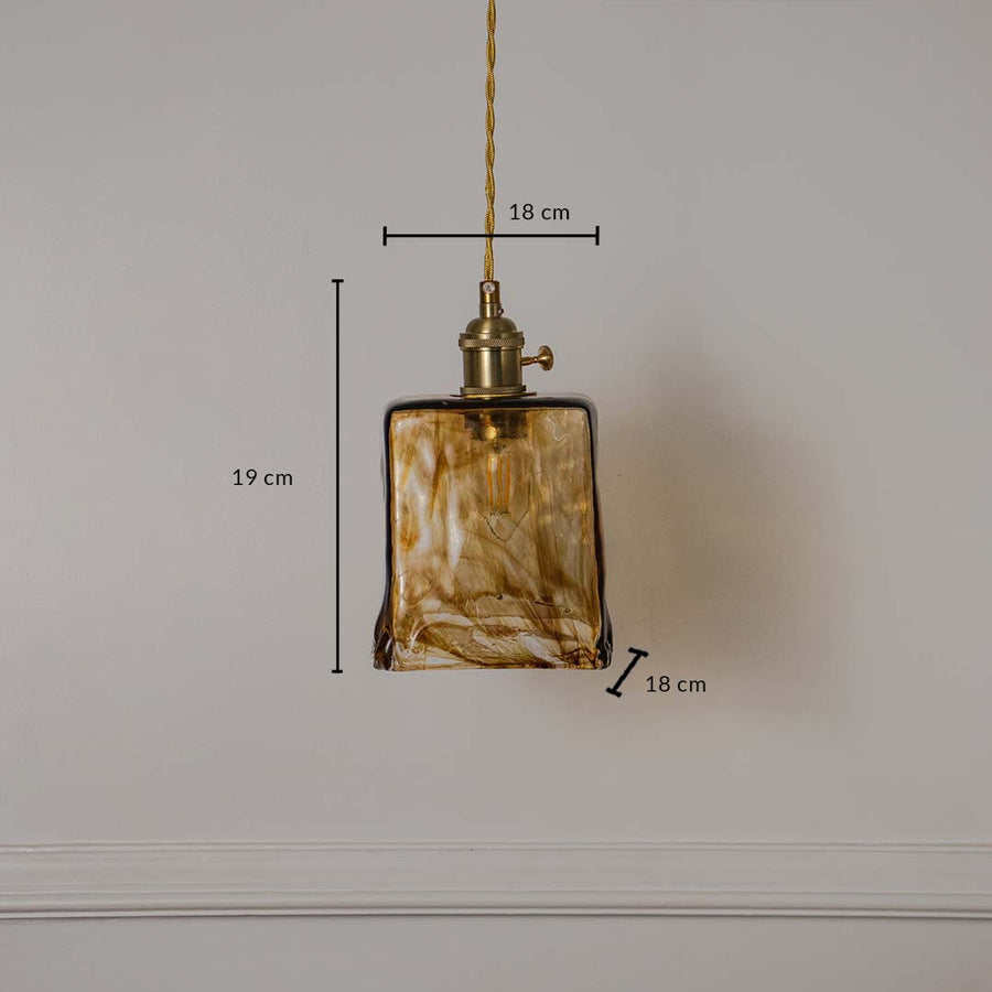 Dimension image of amber marbled square glass pendant light with brass accents showing 19 cm height and 19 cm width.