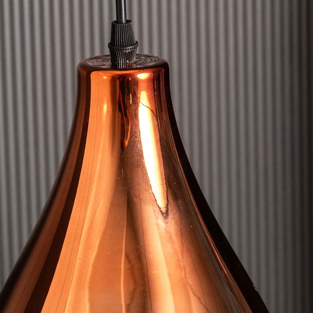 A detailed close view of the tall bronze glass pendant light highlighting its smooth sculpted form and warm metallic finish suited for premium decor.