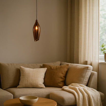 A modern bronze tinted glass pendant light glowing softly above a beige sofa creating warm ambient lighting ideal for living rooms reading corners and cozy interiors.
