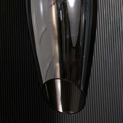 A closeup view of the smoked black pendant light showing the smooth curved glass surface and warm reflective glow ideal for premium interiors.