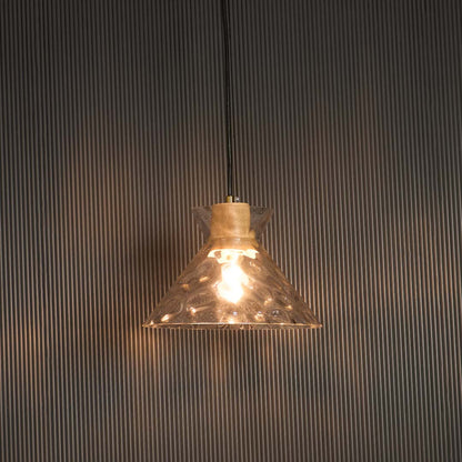 Clear glass pendant light with wooden holder glowing warmly against black background for premium home lighting.
