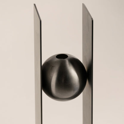 Detailed closeup of the Black Metal Sphere Vase showing its high-quality metal craftsmanship and smooth brushed texture.