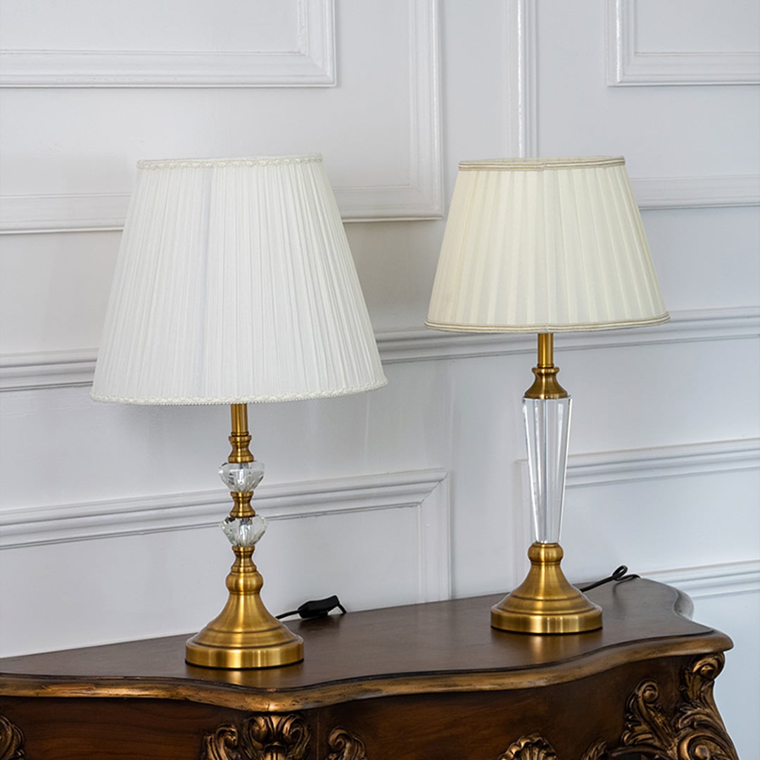 Crystal table lamps grouped together with pleated white shades and gold bases perfect for luxury home lighting and decoration.