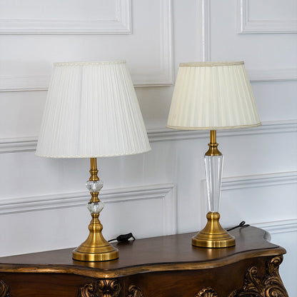 Crystal table lamps grouped together with pleated white shades and gold bases perfect for luxury home lighting and decoration.