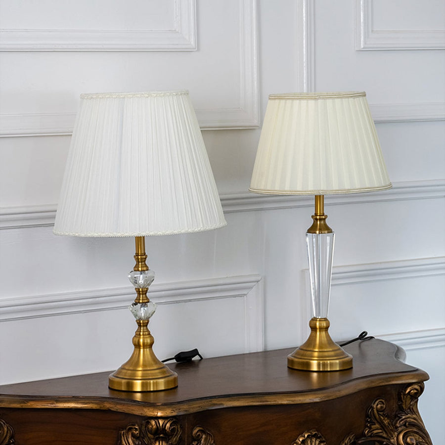 Crystal table lamps grouped together with pleated white shades and gold bases perfect for luxury home lighting and decoration.