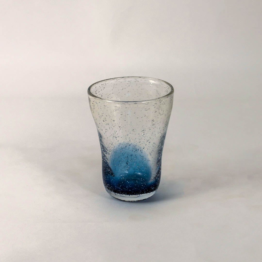 Handcrafted blue gradient vase with textured bubble effect and transparent top placed on a white background.