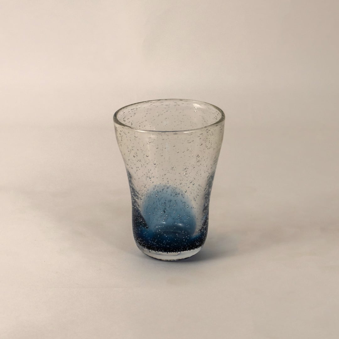Elegant blue and clear glass vase featuring a modern tapered shape and artistic air bubble detailing.