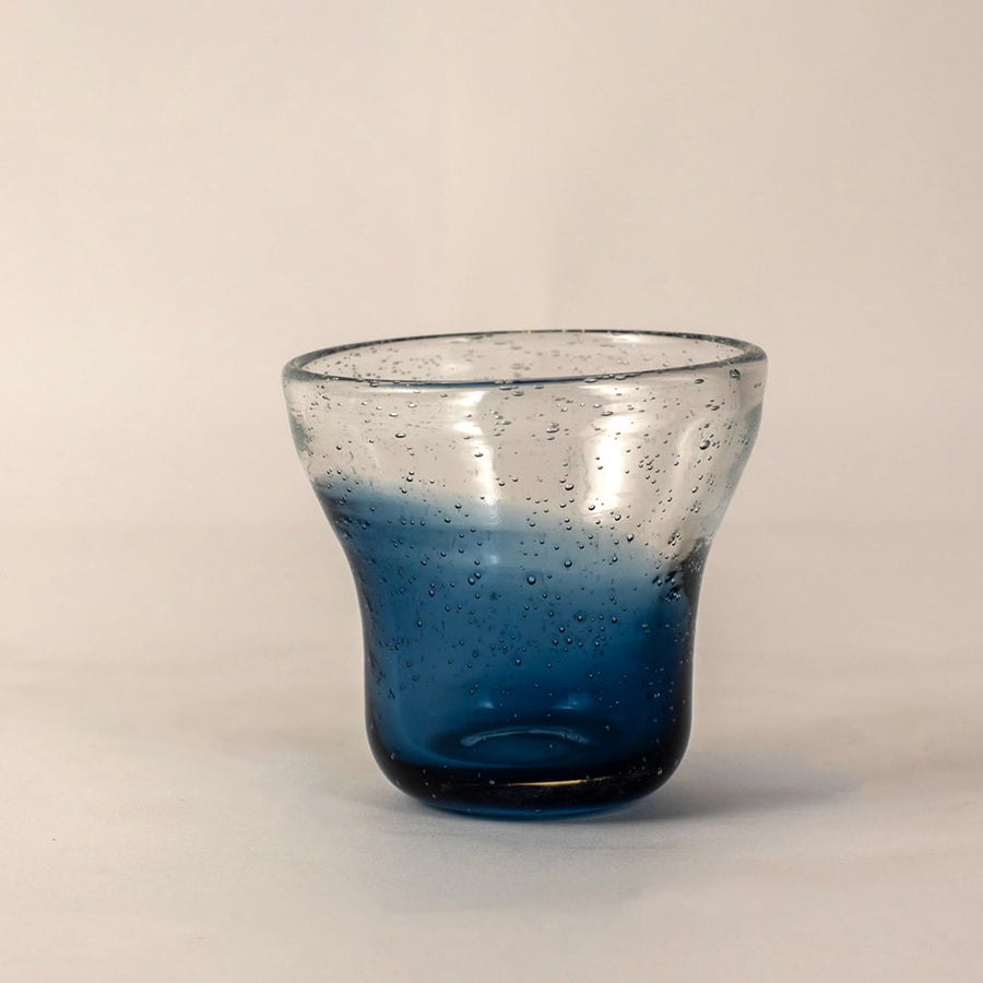 Side angle view of blue bubble glass vase highlighting its unique gradient tones and rounded handcrafted structure.