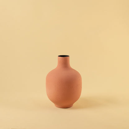 Elegant matte terracotta round vase for modern home decor and stylish minimalist shelf display accents.