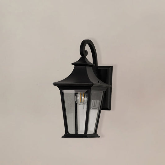 Black metal outdoor wall lantern with clear glass panels shown off on white background for exterior wall use.