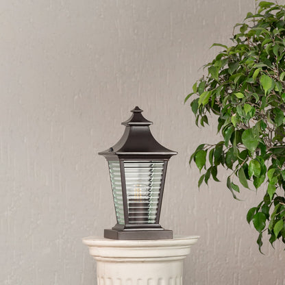 Stylish outdoor black metal pillar light with textured glass body displayed on a white background for porch lighting.