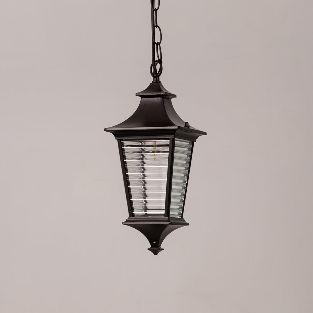 Black metal outdoor hanging lantern with ribbed glass displayed on white background for classic exterior decor styling.