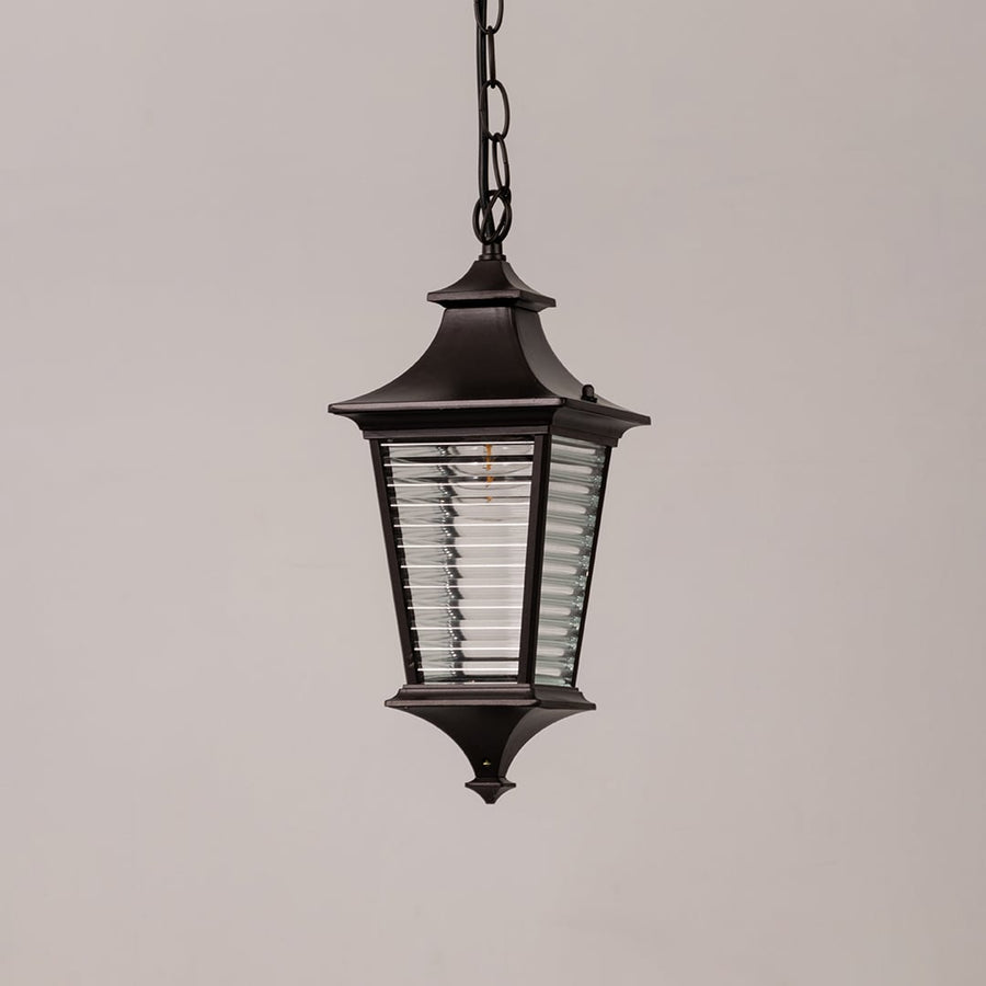 Black metal outdoor hanging lantern with ribbed glass displayed on white background for classic exterior decor styling.