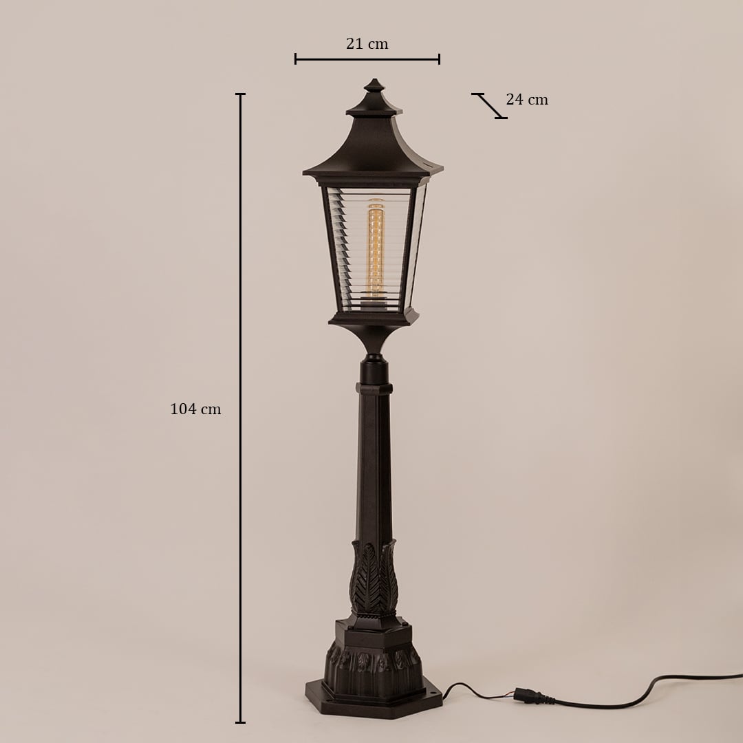 Black metal pillar lamp with ribbed glass measuring height 104 cm width 21 cm depth 24 cm shown on white background.