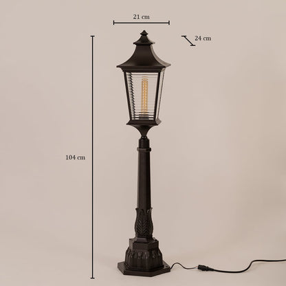 Black metal pillar lamp with ribbed glass measuring height 104 cm width 21 cm depth 24 cm shown on white background.